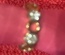 Adjustable Gold Ring, white crystals, band perforated with holes.  Size 6.
