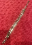 Gold, 3 strand bracelet with a crystal clasp